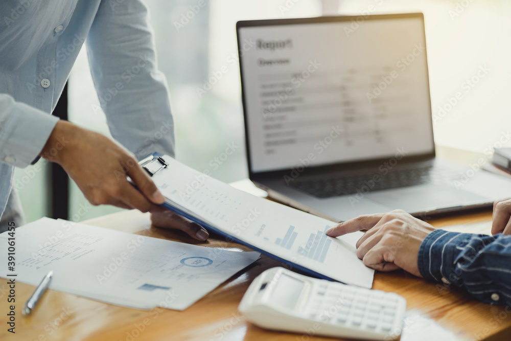 Startup business people teamwork calculating a valuation in workplace. Startup business people teamwork calculating a valuation in workplace.