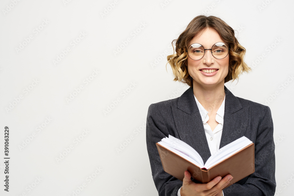 business woman in a suit with documents in hands light background curly hair hairstyle business woman in a suit with documents in hands light background curly hair hairstyle