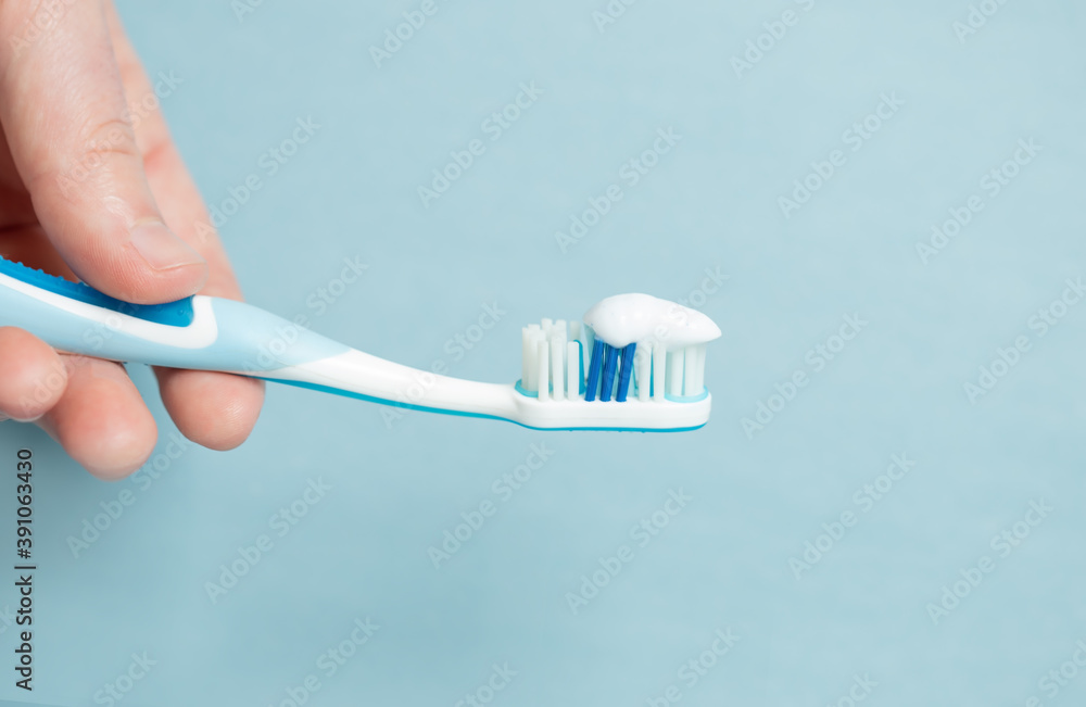 Young woman holding a blue toothbrush Young woman holding a blue toothbrush