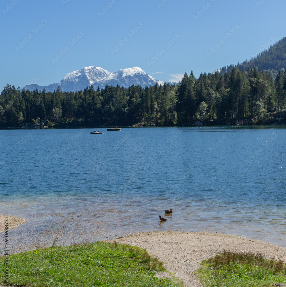 Berchtesgaden lake Hintersee with trees in foreground and mountains in the background on a summer day Berchtesgaden lake Hintersee with trees in foreground and mountains in the background on a summer day