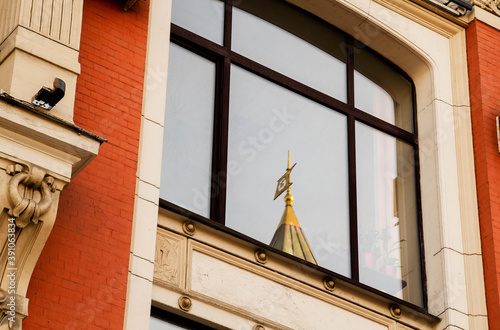 Reflection of the dome of a historic building in a windoww, the Russian-concept of communication of architectural styles. photo