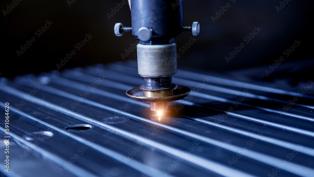 The laser cutting machine cutting the holes on pipes The laser cutting machine cutting the holes on pipes
