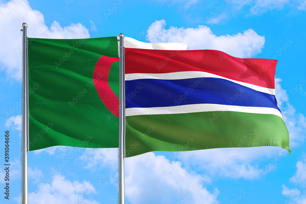 Gambia and Algeria national flag waving in the windy deep blue sky. Diplomacy and international relations concept.
