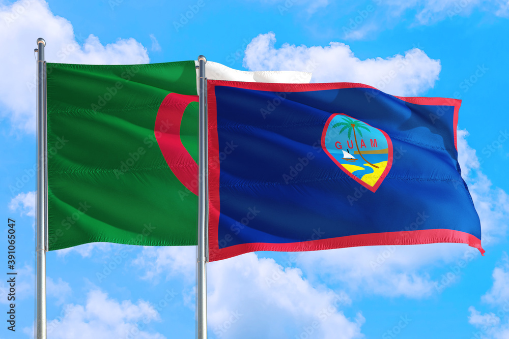 Guam and Algeria national flag waving in the windy deep blue sky. Diplomacy and international relations concept. Guam and Algeria national flag waving in the windy deep blue sky. Diplomacy and international relations concept.