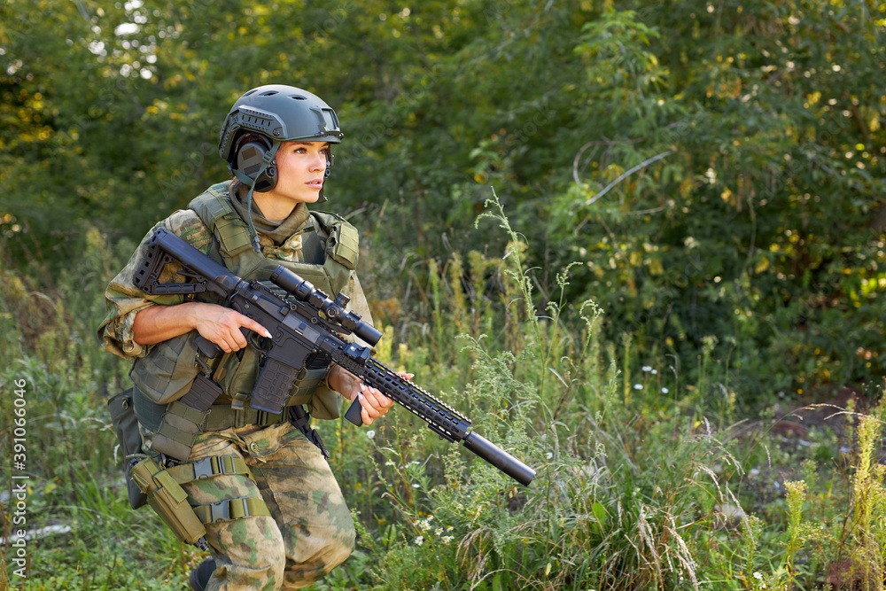 Fototapeta premium military woman has hobby activity, practice lends success hunting, female has hunting experience in nature environment. hunting weapon gun or rifle, hunting target concept