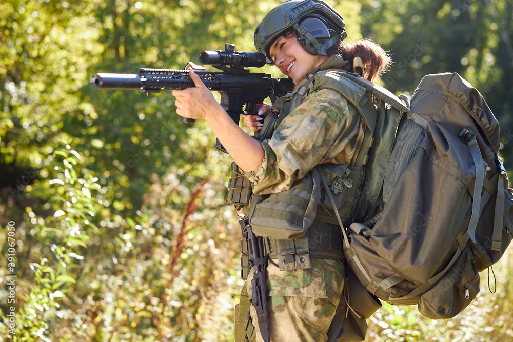 sportive caucasian woman soldier shooting with rifle machine gun in the forest, young slim female is hunting sportive caucasian woman soldier shooting with rifle machine gun in the forest, young slim female is hunting