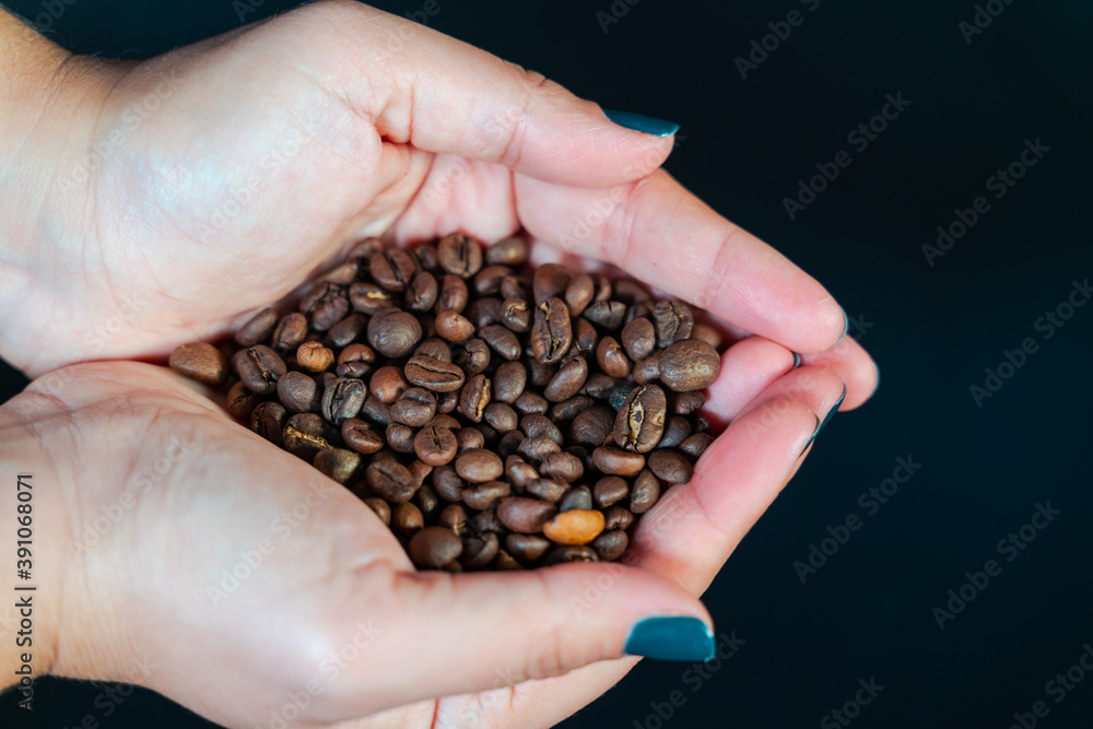 Coffee grains in woman hand. Coffee grains in woman hand.
