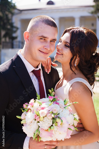 Fotografie Newlywed walk in  park.Bride and groom together outdoors.
