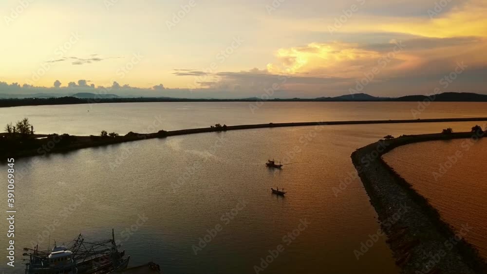 Aerial view of the landscape with fishing boats in the sea on a sunset day. Aerial view of the landscape with fishing boats in the sea on a sunset day.