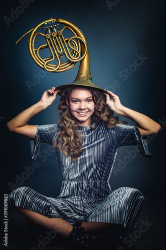 Girl with a French horn on her head