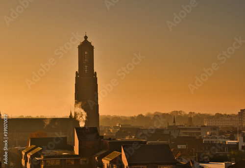 Martinus church at an orange sunset with fog in Weert the Netherlands, photo made on 5 november 2020