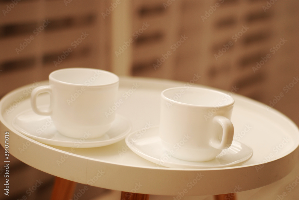 Pair of tea cups on a white tray