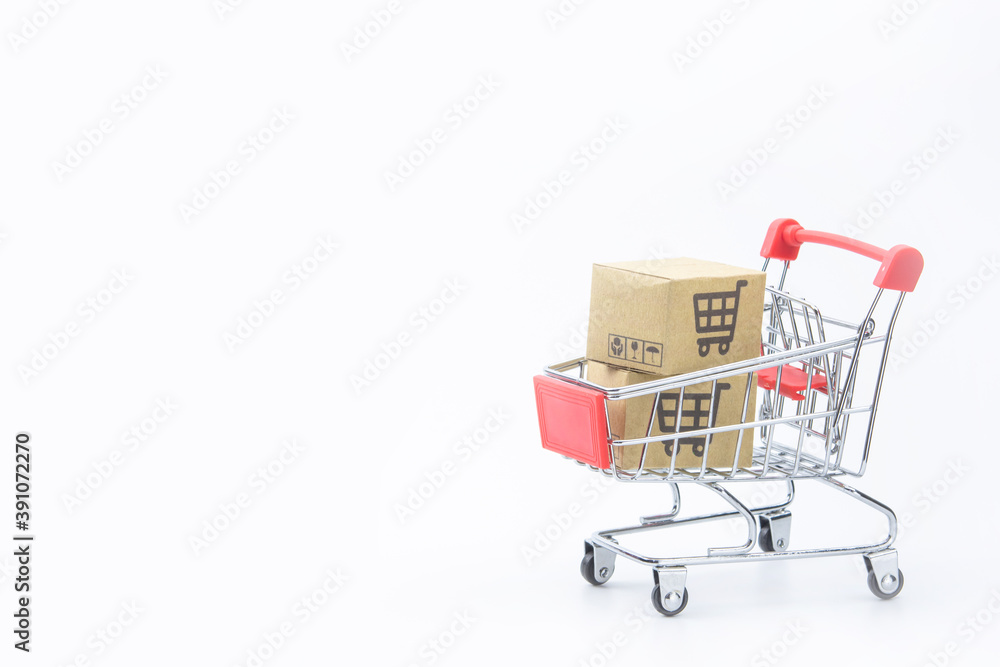 Shopping concept - Cartons or Paper boxes in red shopping cart on white background. online shopping consumers can shop from home and delivery service. with copy space.