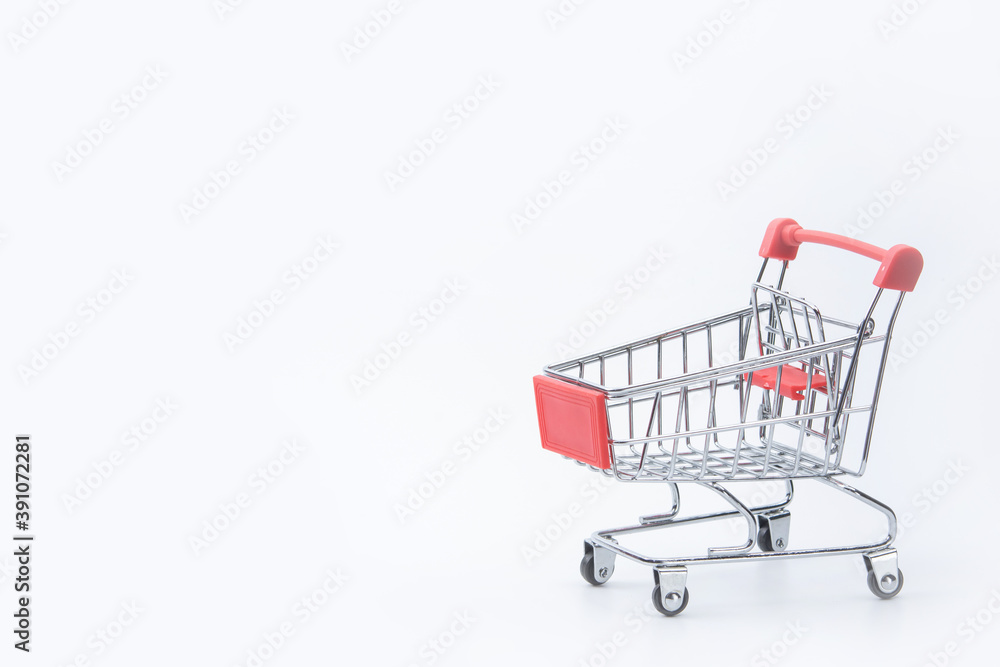 Shopping concept - Red shopping cart on white background with copy space.