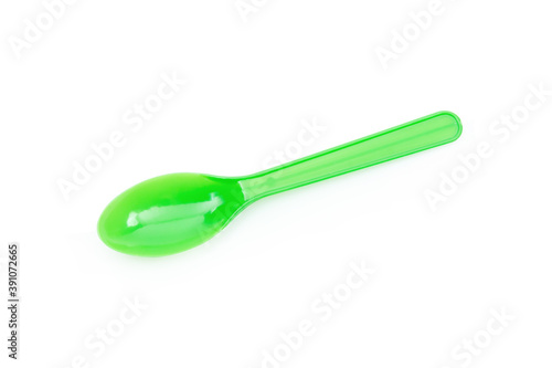 Green plastic spoon isolated on white background.