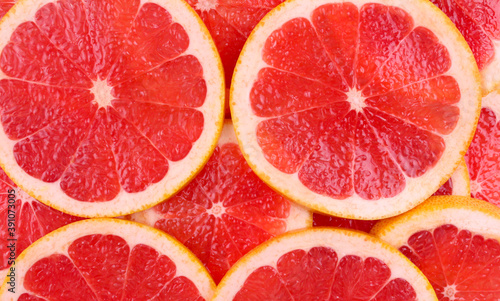 Background of sliced red round grapefruit