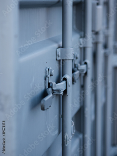 Grey metal container doors that are closed © Robin