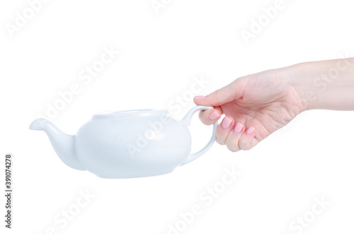 White ceramic teapot in hand on white background isolation