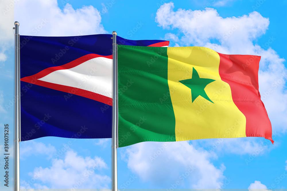 Senegal and American Samoa national flag waving in the windy deep blue sky. Diplomacy and international relations concept.