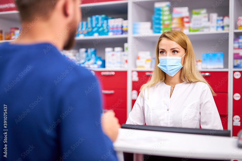 professional female pharmacist helping male customer choosing prescription drugs, consult sick clients. shopping at drugstore, taking advice from young chemist. Consumerism, friendly staff concept