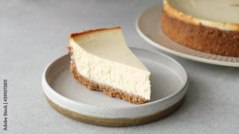 Serving slice of cheesecake on a plate. Classical New York style cheesecake Serving slice of cheesecake on a plate. Classical New York style cheesecake