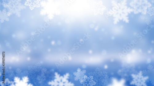 Wide blurred winter background. The sun is shining in snowflakes. Abstract blue Christmas background. Panorama. © 151115