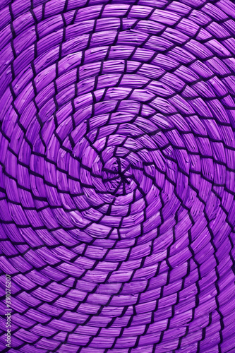 Spiral pattern of woven water hyacinth place mat in vivid purple color © jobi_pro