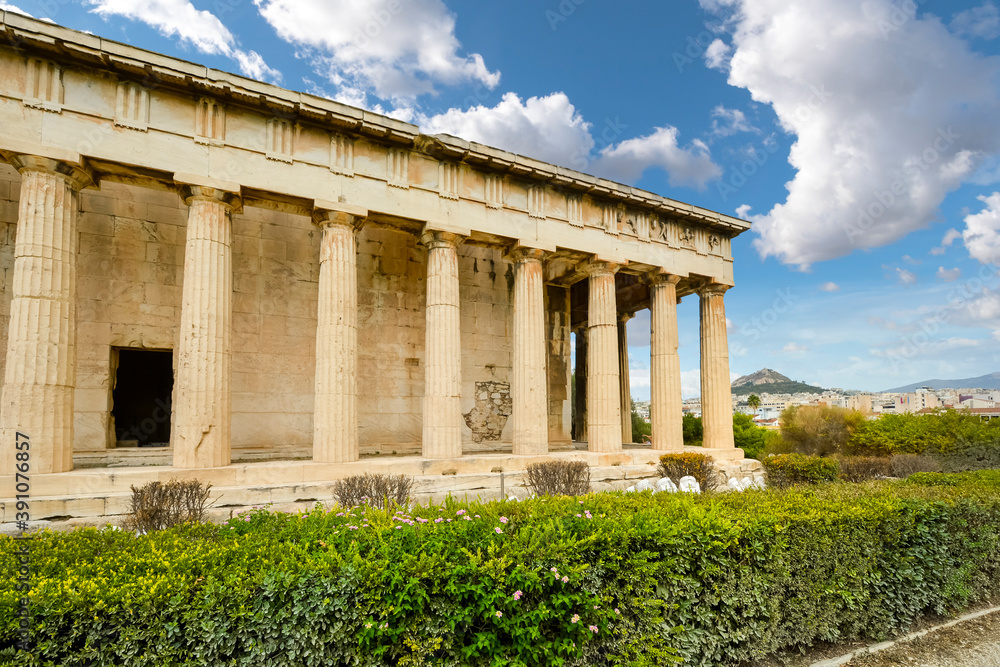 The Temple of Hephaestus or Hephaisteion with Lykavittos Hill in the background in Athens, Greece The Temple of Hephaestus or Hephaisteion with Lykavittos Hill in the background in Athens, Greece