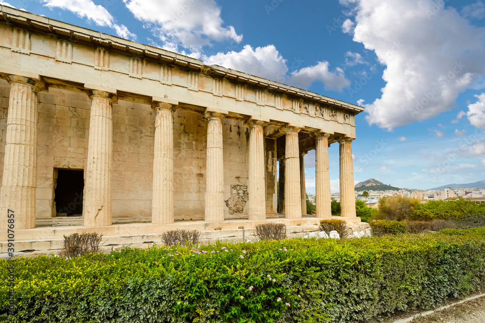 The Temple of Hephaestus or Hephaisteion with Lykavittos Hill in the background in Athens, Greece