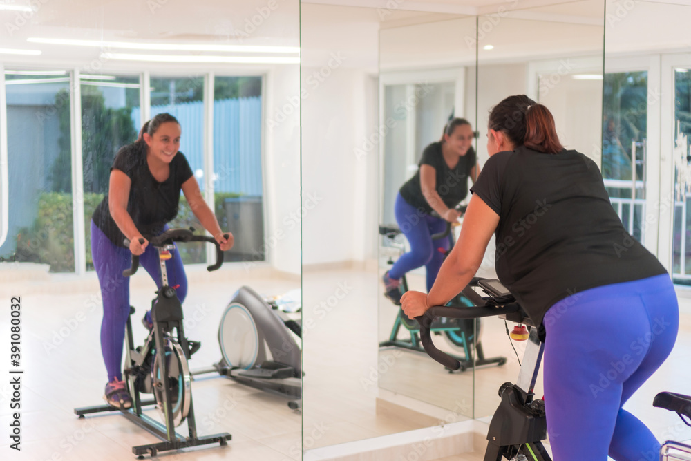 Woman in spinning class in gym Woman in spinning class in gym