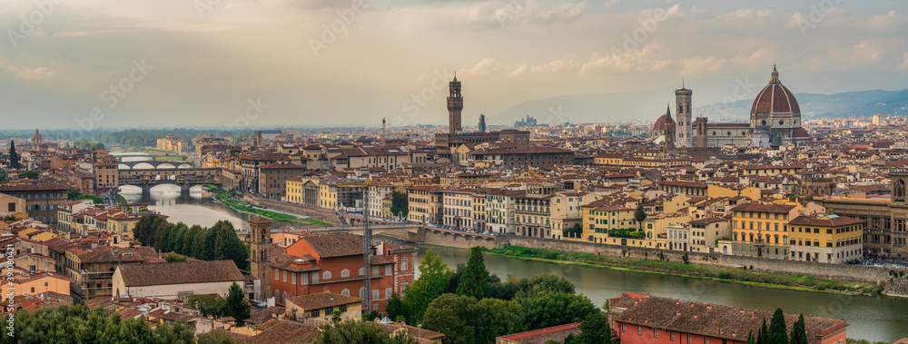 Florence old city skyline at sunset with Ponte Vecchio over Arno River and Cathedral of Santa Maria del Fiore in Florence, Tuscany, Italy.