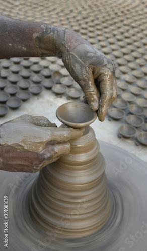 A potter makes diyas or clay lamps or earthen lamps on potter's wheel ahead of Diwali festival in Beawar, Rajasthan, India. Photo: Sumit Saraswat photo