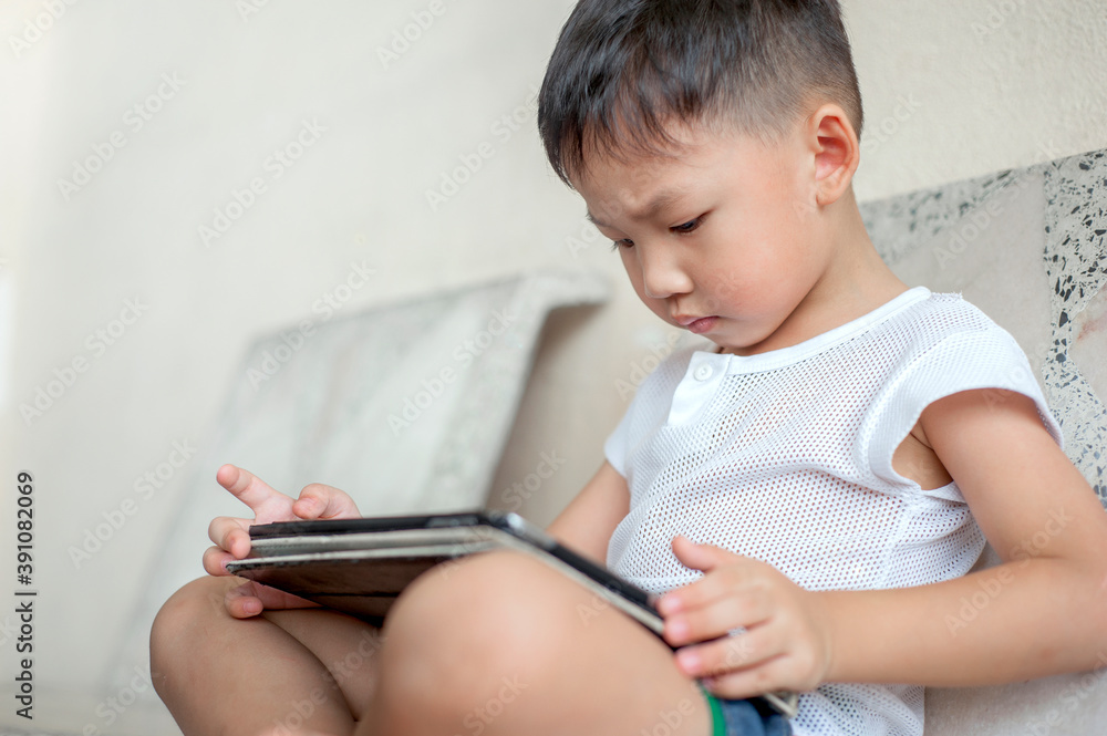 Little kid's using Digital Touchscreen Phone Tablet computer playing games. Little kid's using Digital Touchscreen Phone Tablet computer playing games.