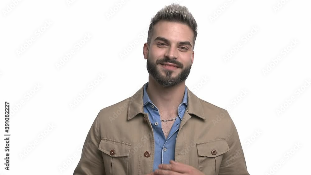 attractive casual guy rubbing palms, arranging beige jacket, holding hands in pockets and smiling isolated on white background in studio attractive casual guy rubbing palms, arranging beige jacket, holding hands in pockets and smiling isolated on white background in studio
