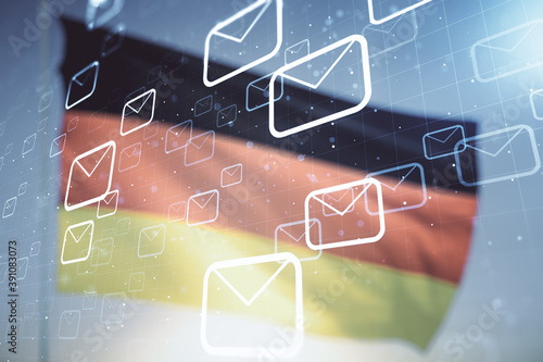 Photography Double exposure of abstract virtual postal envelopes hologram on German flag and blue sky background