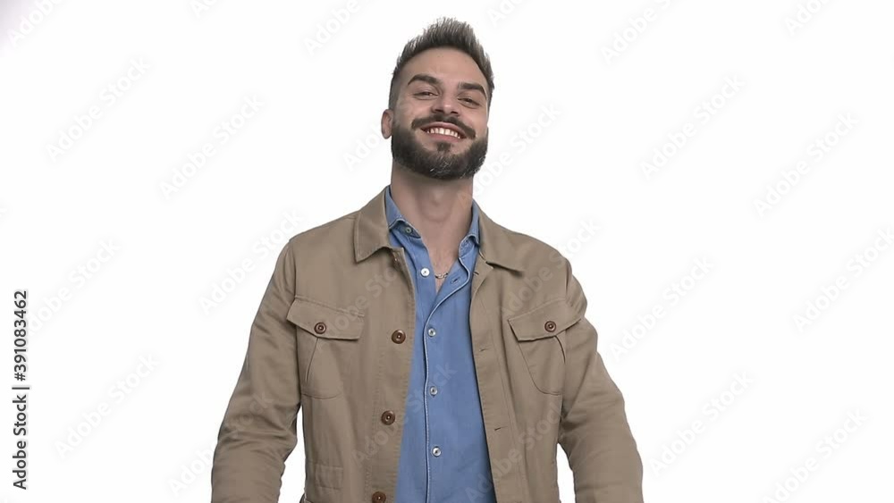 happy young man in denim shirt smiling, holding arms up and making peace gesture, standing isolated on white backgrounding studio