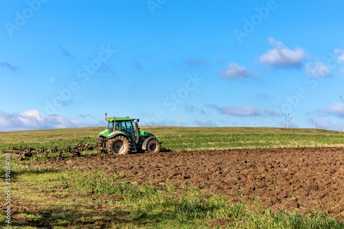 Ploughing in the fields. Tractor plows a field. Autumn agricultural landscape in the Czech Republic. Autumn morning in the field.