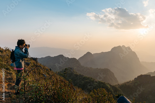 Adventure photographers taking photos of Mountain and landscape in the dusk near the sunset at Doi Luang Chiang Dao, Chiang Mai, Thailand. Taking from top of the mountain.