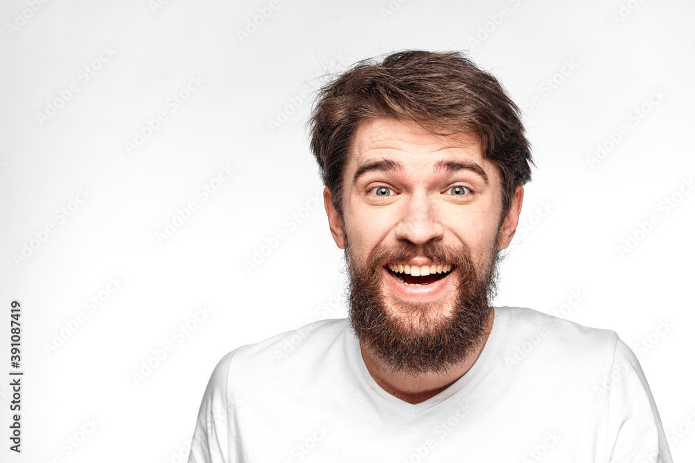 cheerful emotional bearded man gesturing with his hands close-up light background cheerful emotional bearded man gesturing with his hands close-up light background