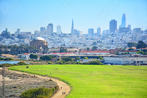 View from the Golden Gate Bridge overlooking Crissy Field and the Presidio of San Francisco with skyline in background on a clear sunny day