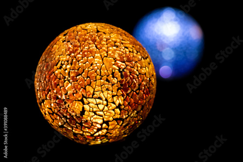 Golden planet with white blue star in deep black space.