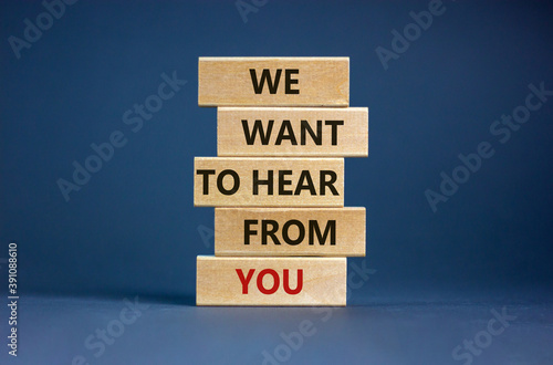 Wooden blocks with words 'we want to hear from you'. Beautiful grey background. Copy space. Business concept.