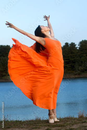 Принти на полотні Adult woman dancing on the shore of a reservoir, Connecticut.