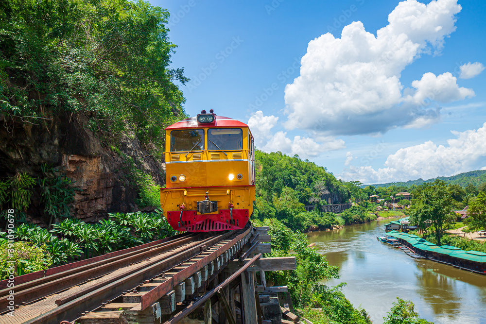 Naklejka premium Kanchanaburi Province, Locomotive, Steam Train, Thailand, Train,World war II historic railway, known as the Death Railway with a lot of tourists on the train taking photos of beautiful views over Kwai