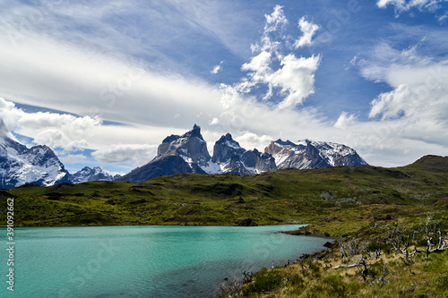 Cuernos, Horns of torres del paine covered with snow,  torres del paine national park in the Andes, southern Chile, south America, towering over the turquoise water of lake Pehoe with dramatic clouds © Jens