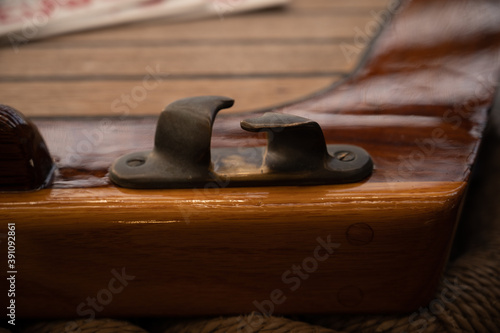 Copper chock on wooden sailboat