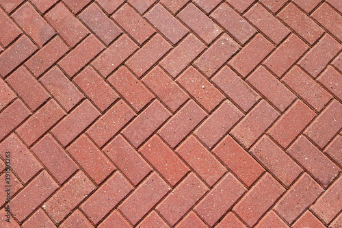 Abstract background from paving red tiles, bricks. Top view of the pavement pattern. Concept for construction, urban environment improvement, finishing works, landscape design