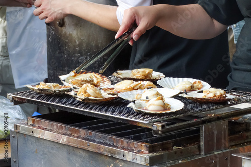 Grilling a scallop shell (hotate), famous japanese street food