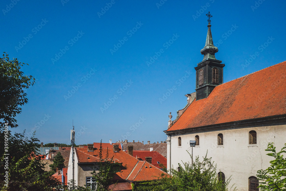 Church with tower in the town of Petrovaradin under blue sky, Novi Sad, Serbia