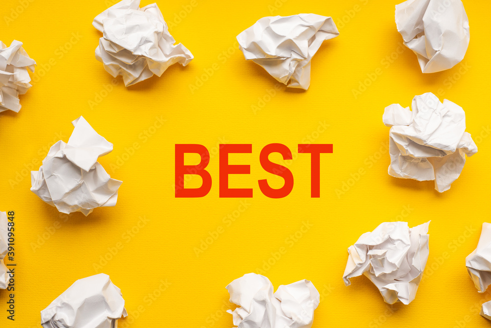 Best text on yellow background with copy space. Crumpled sheets of paper lie around. Business concept image